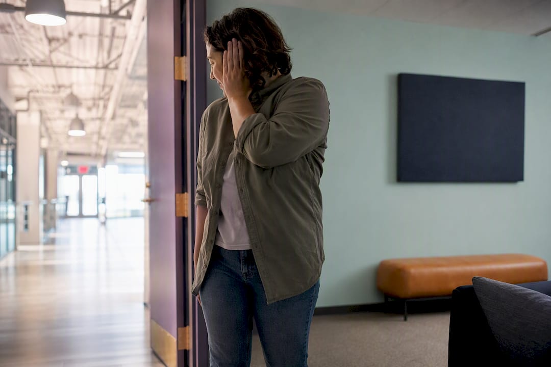 Adult moving from bright hallway to quiet room