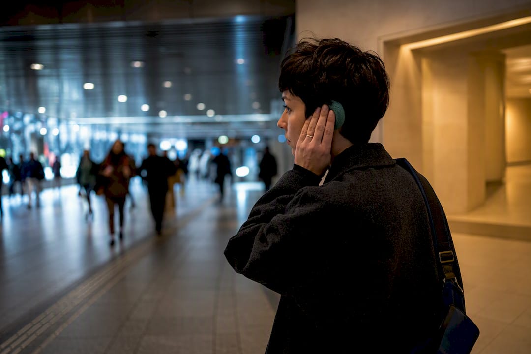 Adulto che controlla un sovraccarico sensoriale in un ambiente pubblico